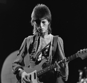 1974 David Bowie playing guitar with his hair in that fuzzy mullet.