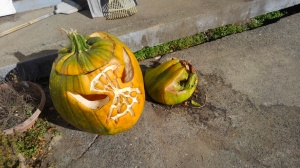 Two green jack o'lanterns. One is worse for the wear, and the other has collapsed inside itself in rot and despair.